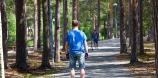 Special Kind Of Modern Urban Transport a man rides a hoverboard through the park