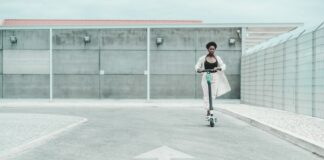 Problems Of A New Type Of Urban Transport a woman rides an electric scooter in an empty parking lot