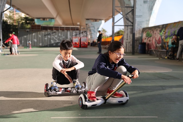 children-riding-hoverboard-on-the-park