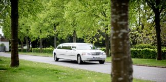 Unveiling Manchester’s Hidden Gems: A Luxurious Limo Journey white limo moving down the street