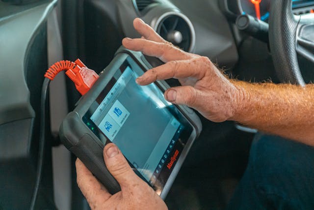 person-holding-blue-diagnostic-tool
